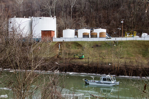 An_environmental_enforcement_boat_patrols_in_front_of_the_chemical_spill_at_freedom_industriesp_medium